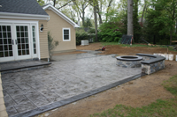 stamped concrete patio and custom firepit and seating wall