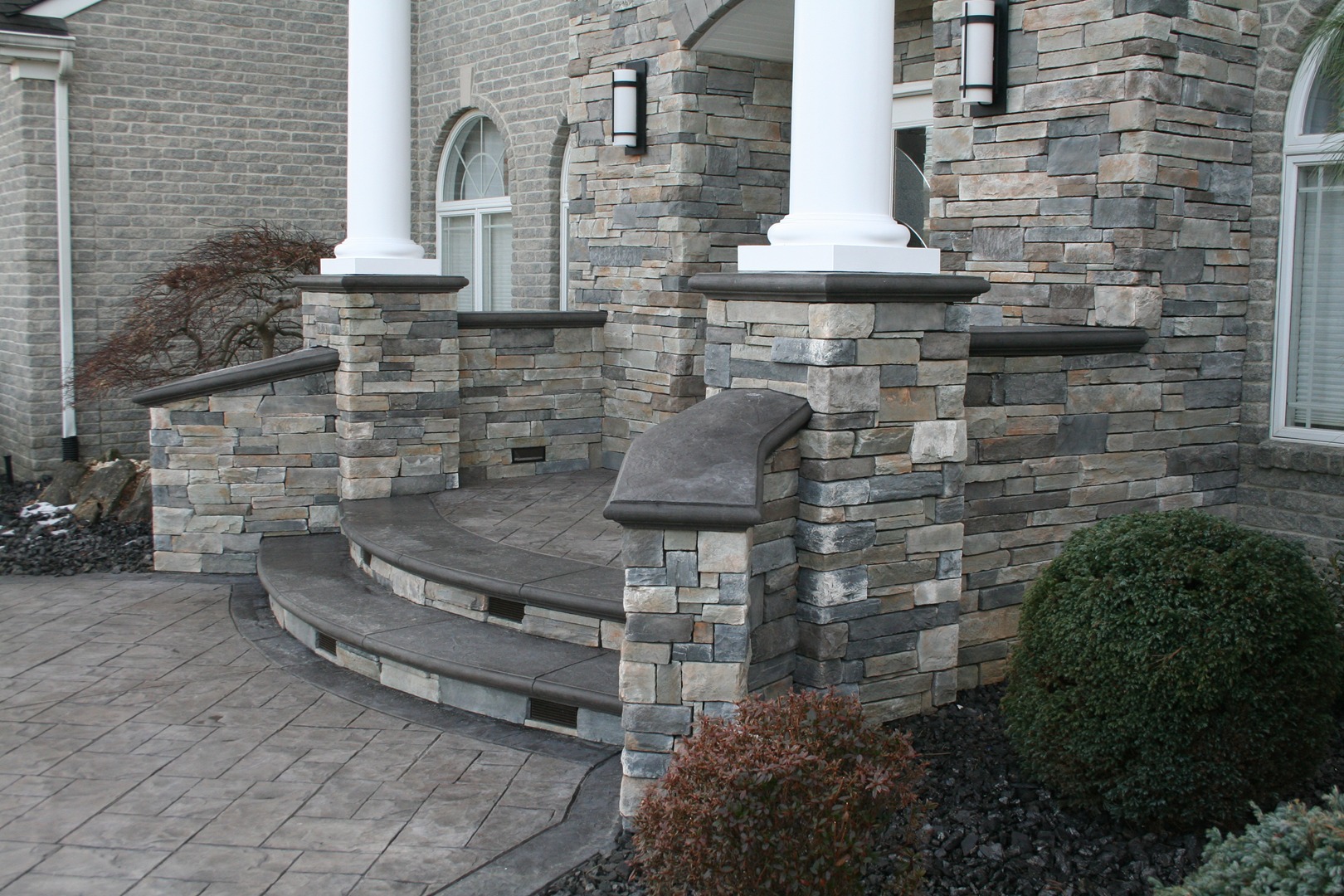 cultured stone entrance with stamped concrete walkway in Freehold, NJ